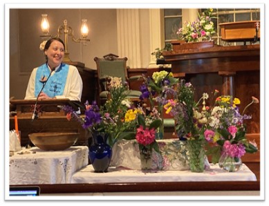 Rev. Tori Rosati and several bouquets of flowers