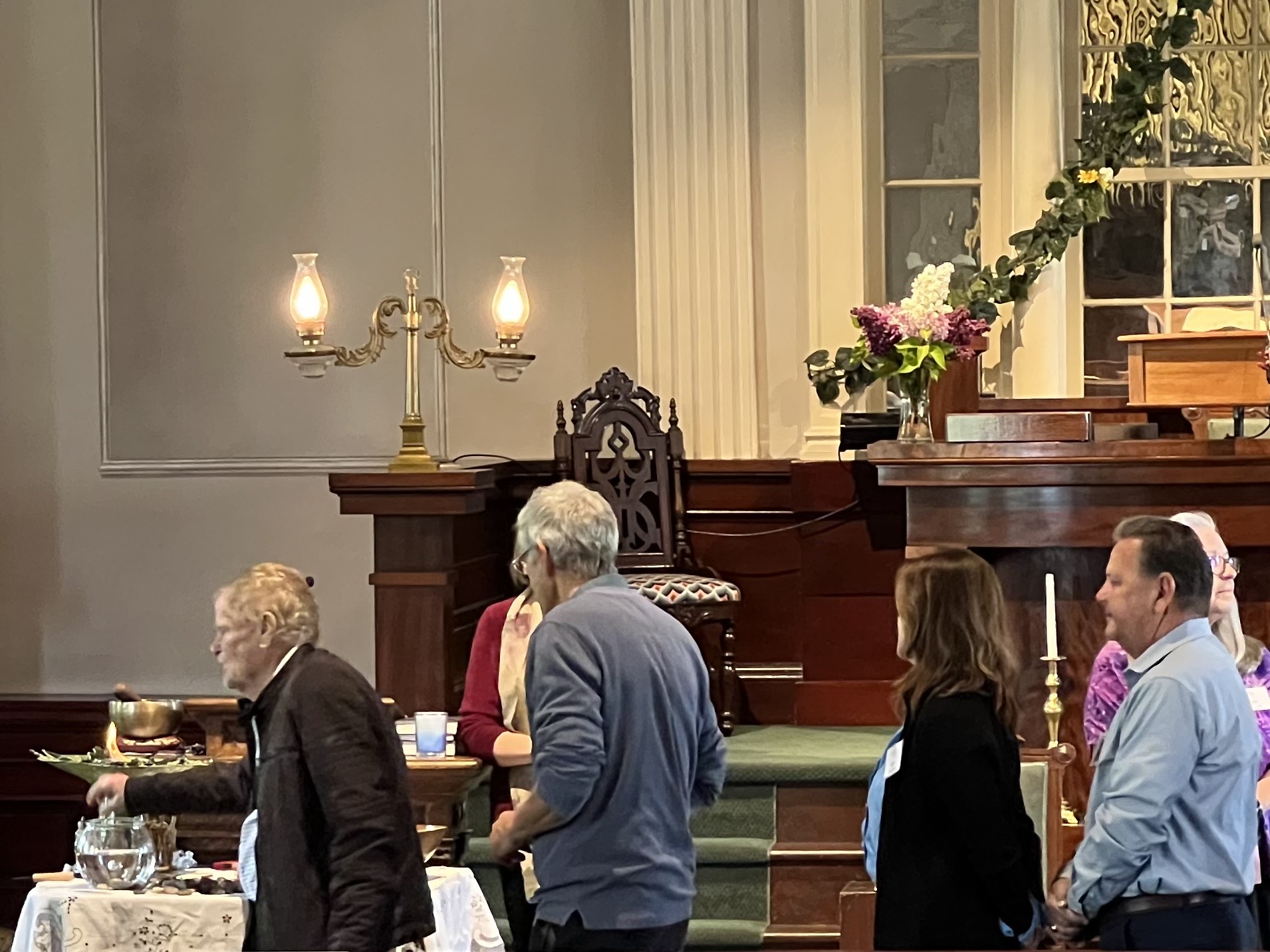 Congregants drop stones in bowl for Joys & Concerns