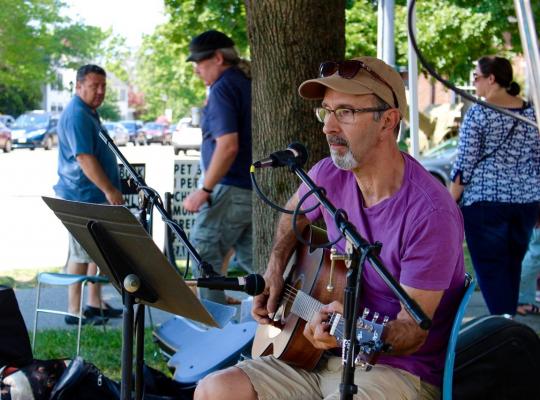 Greard Carey playing guitar outside the church