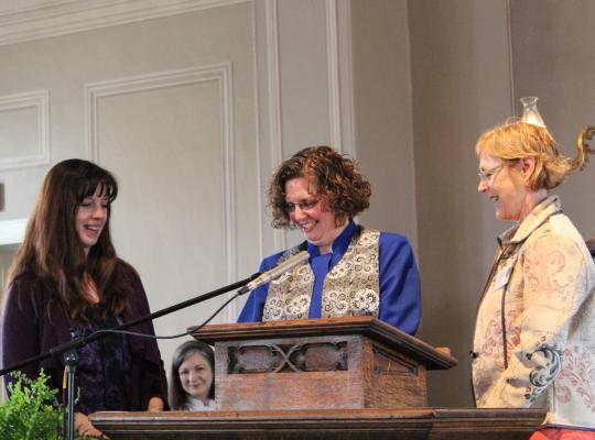 lara at podium being inducted into the church